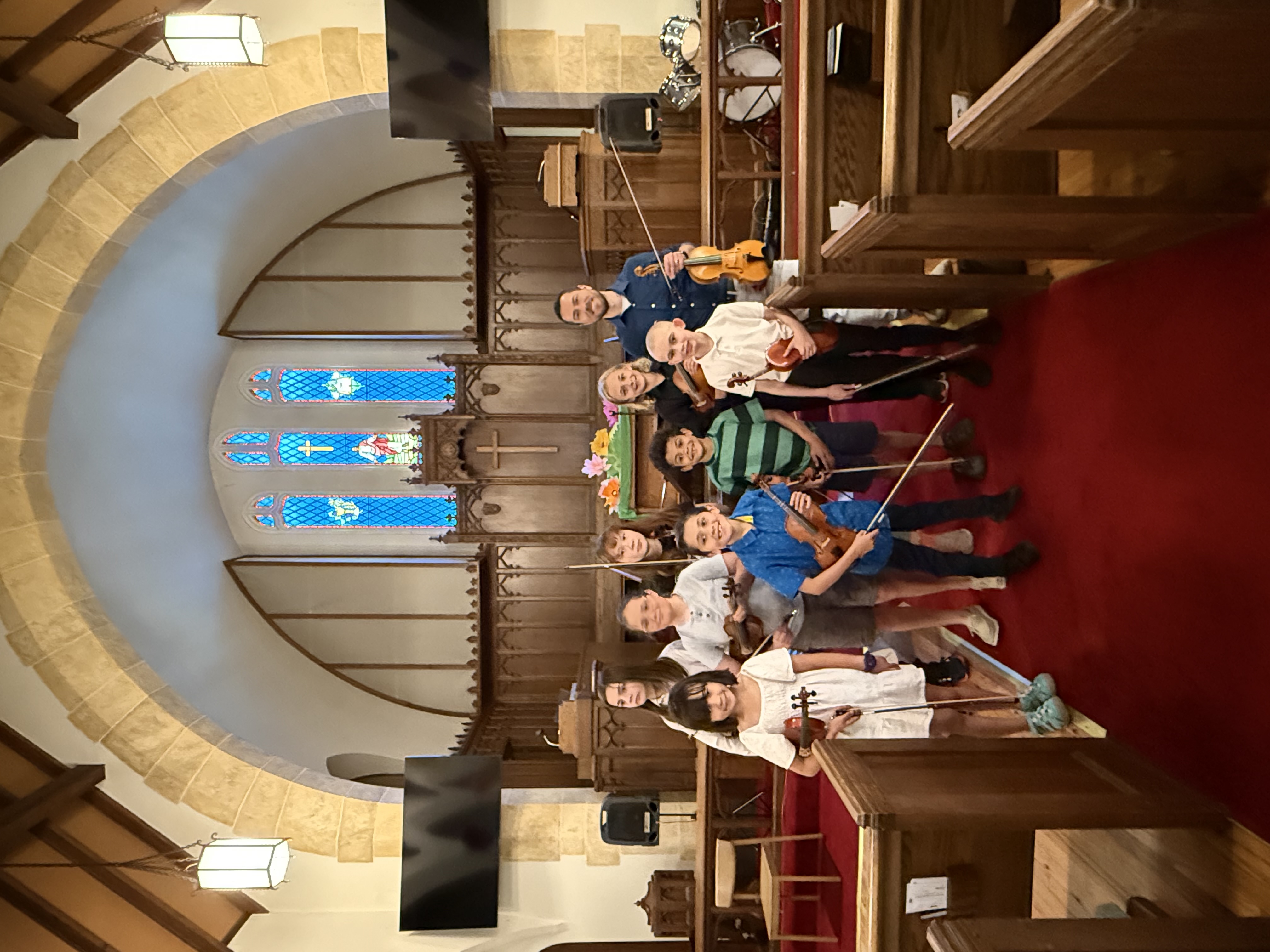 William Samorey with student violinists in a church